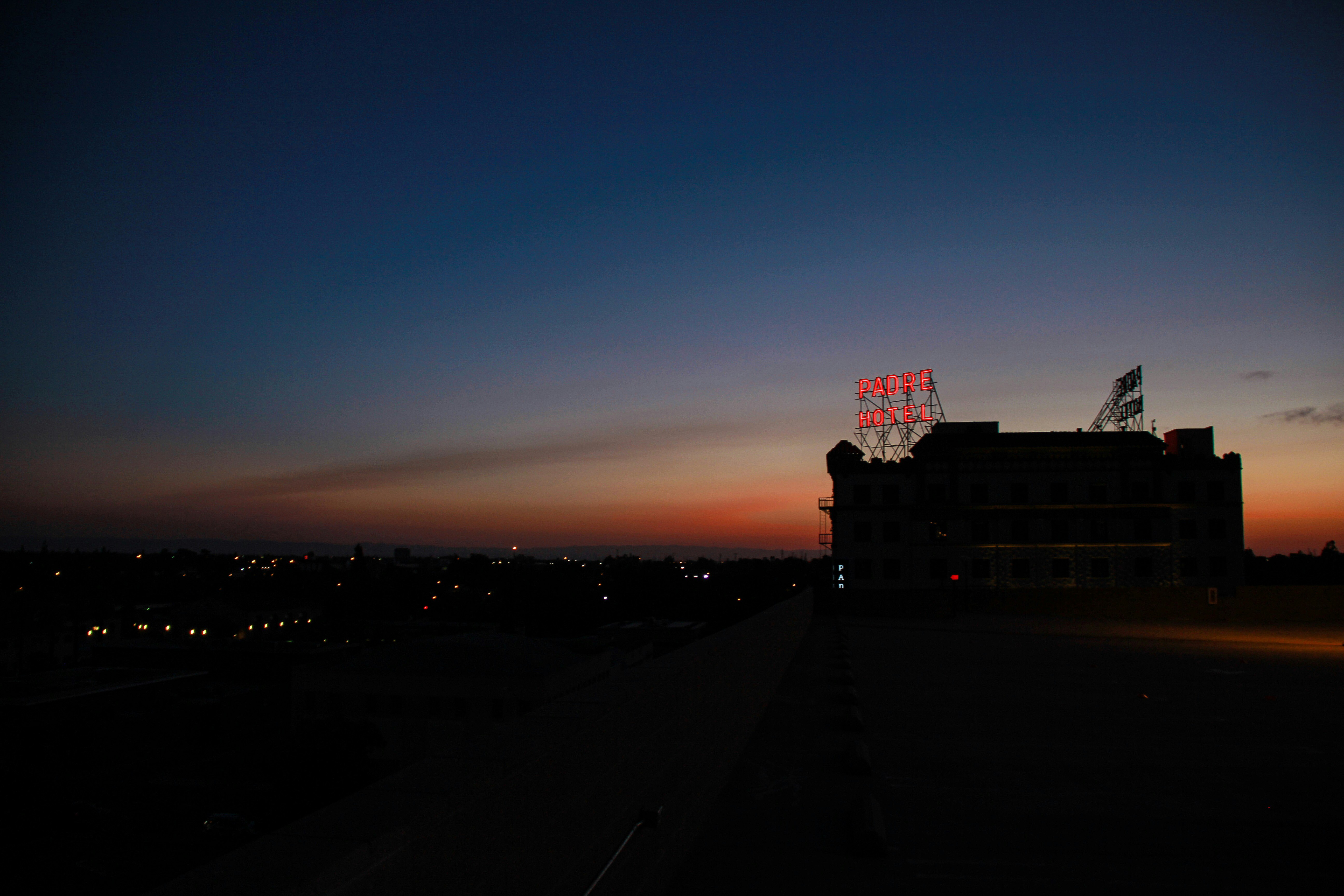 silhouette of concrete building under cloudy sky